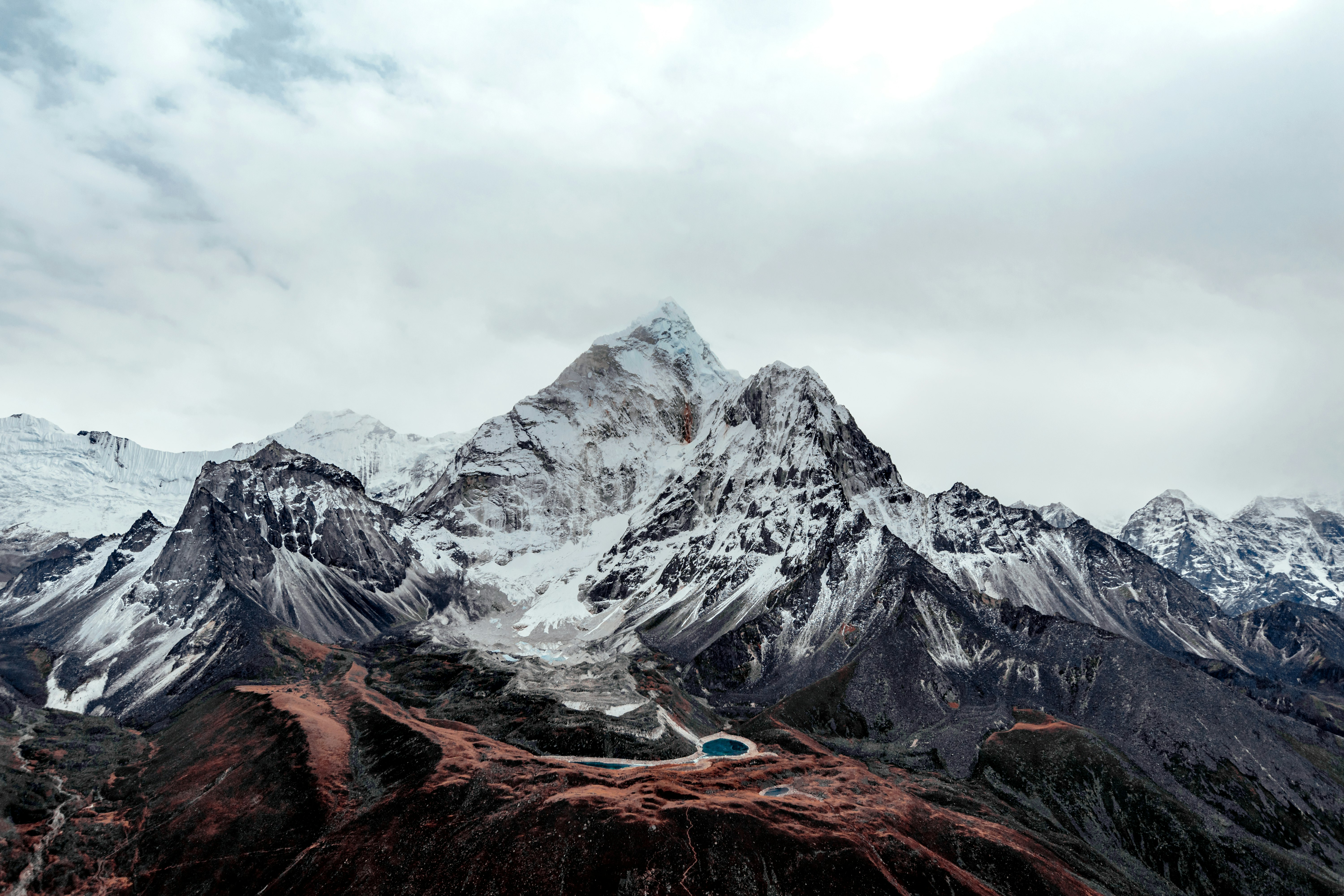 snow covered mountain under cloudy sky during daytime